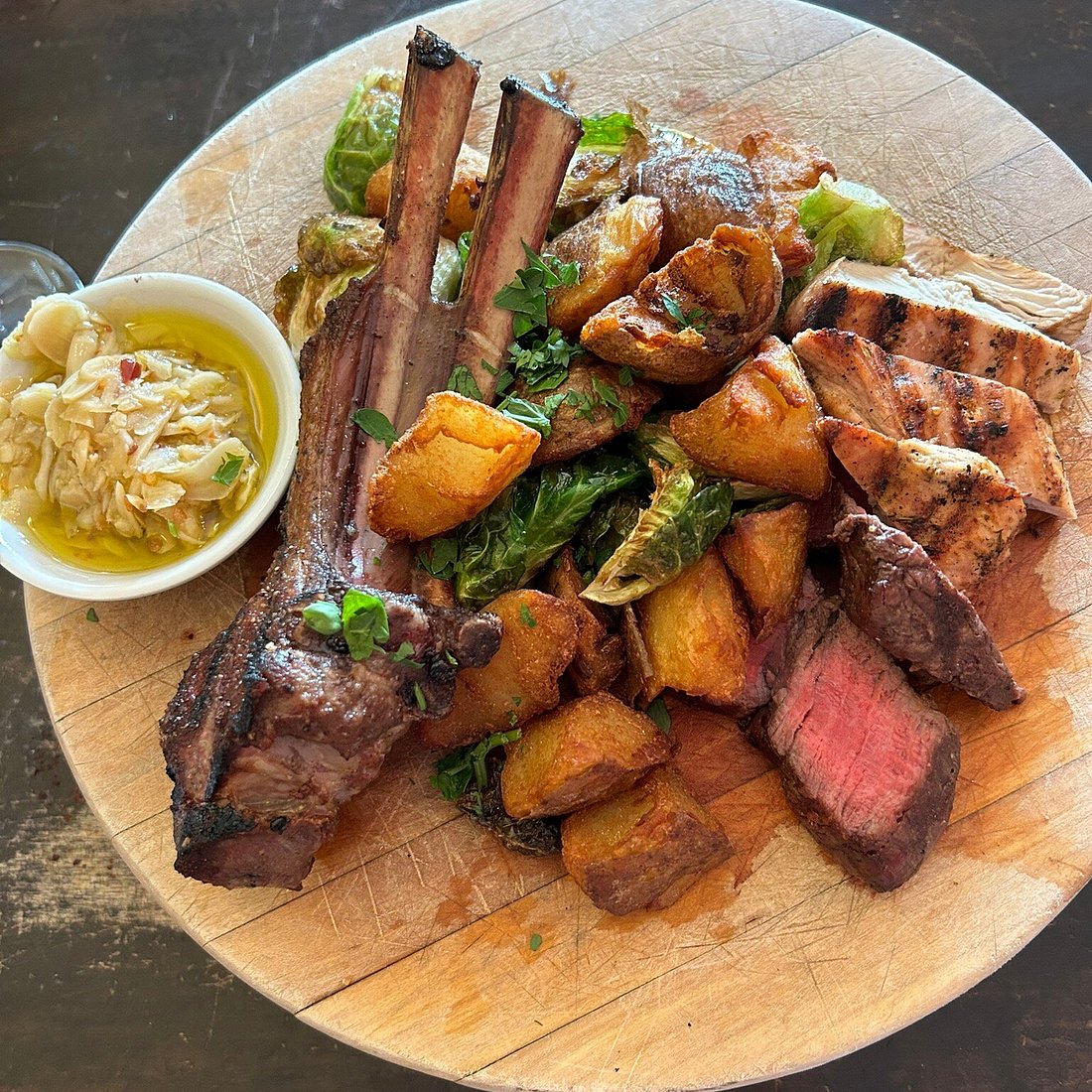 Treva platter with grilled meats, potatoes, and vegetables